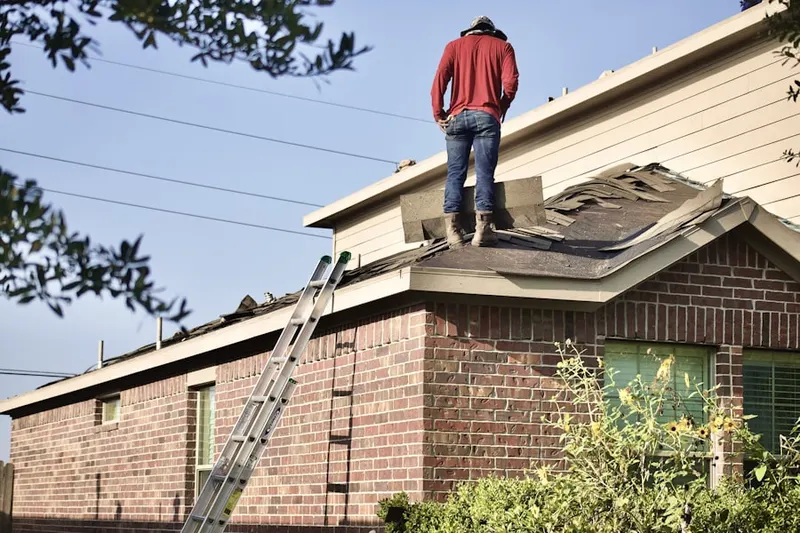Professional roofer working on a residential roof in North Pocasset